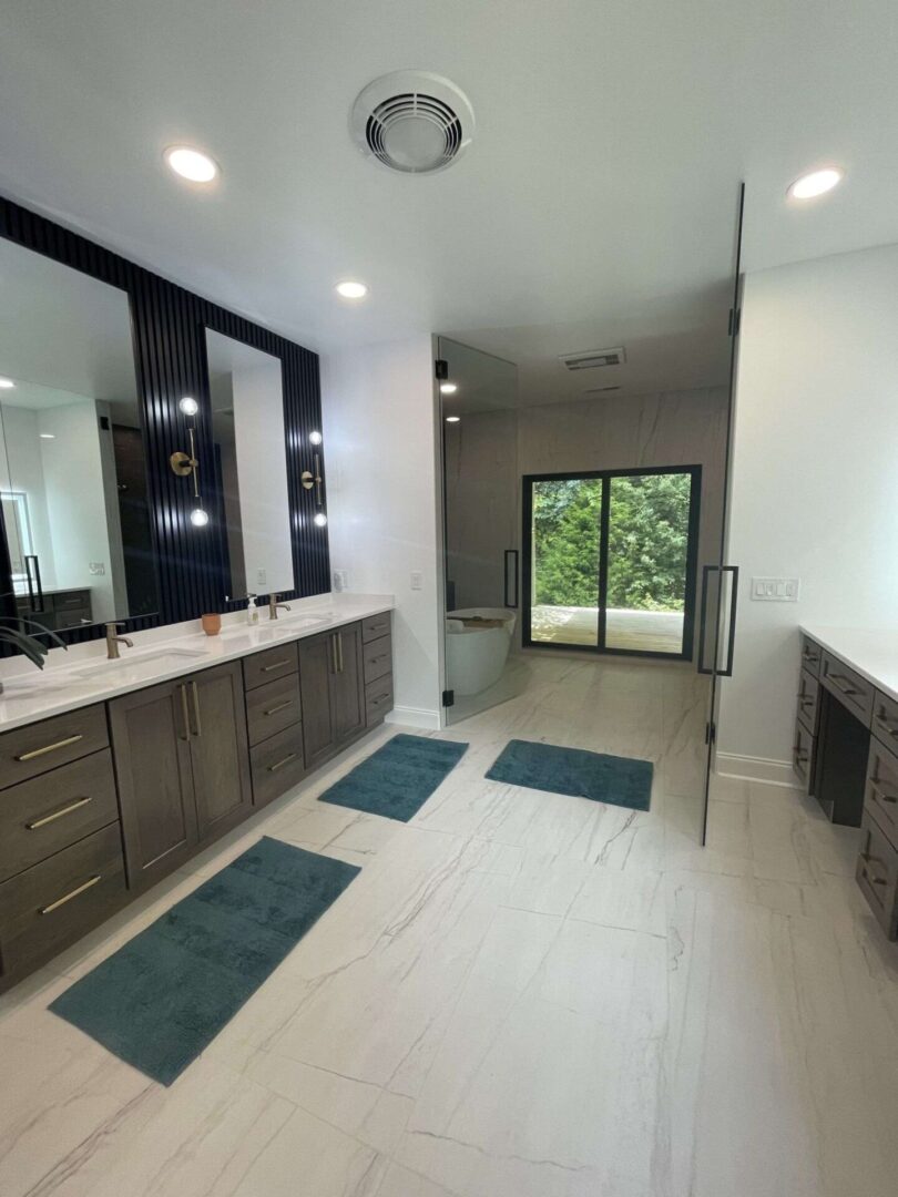 A bathroom with two sinks and a large mirror.