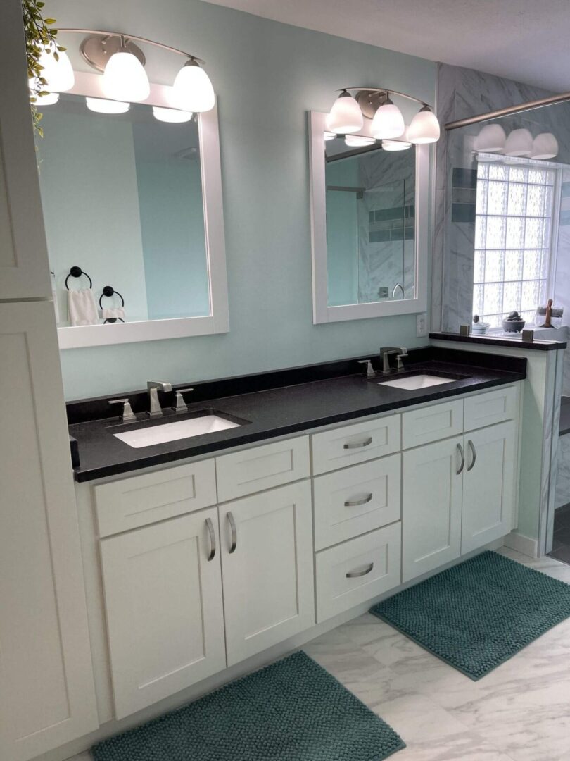 A bathroom with two sinks and mirrors.