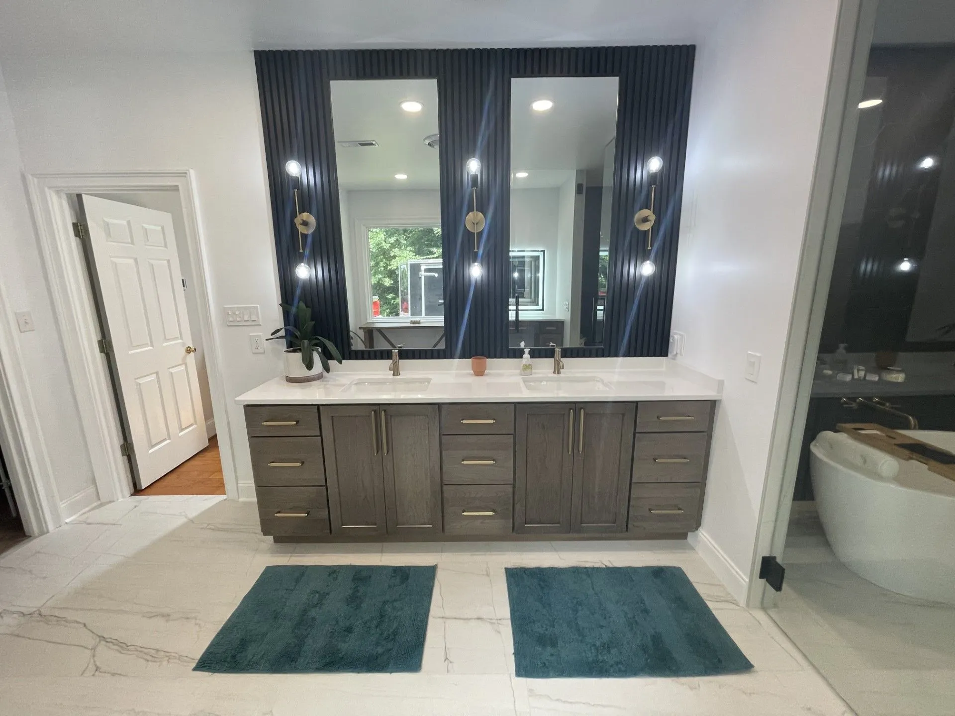 A bathroom with two sinks and a large mirror.