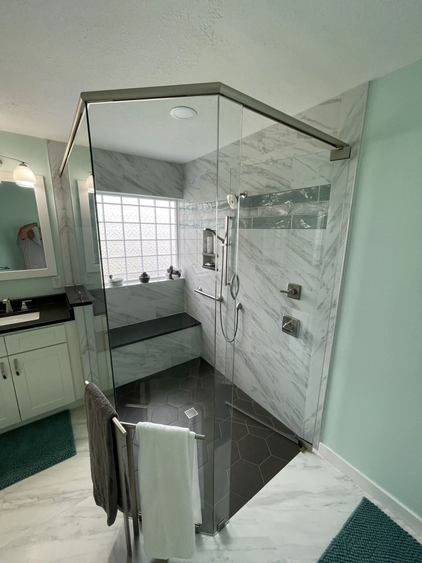 A bathroom with a shower and tiled walls.