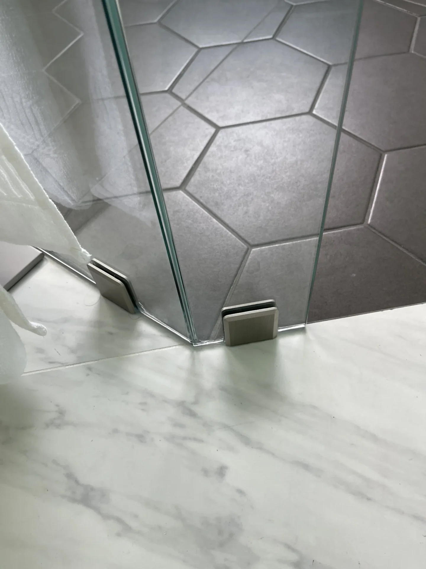 A bathroom with marble floors and walls.