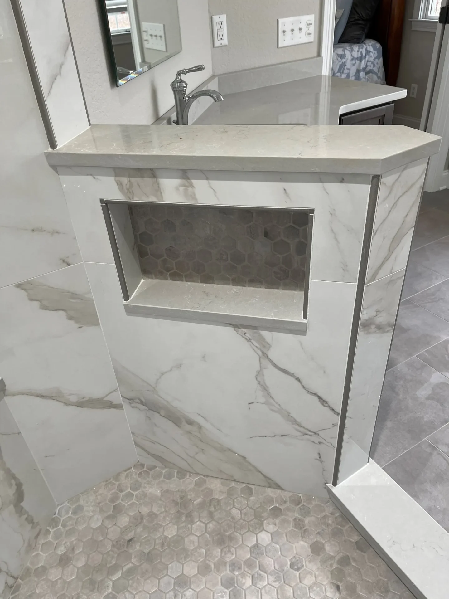 A bathroom with marble walls and floors.