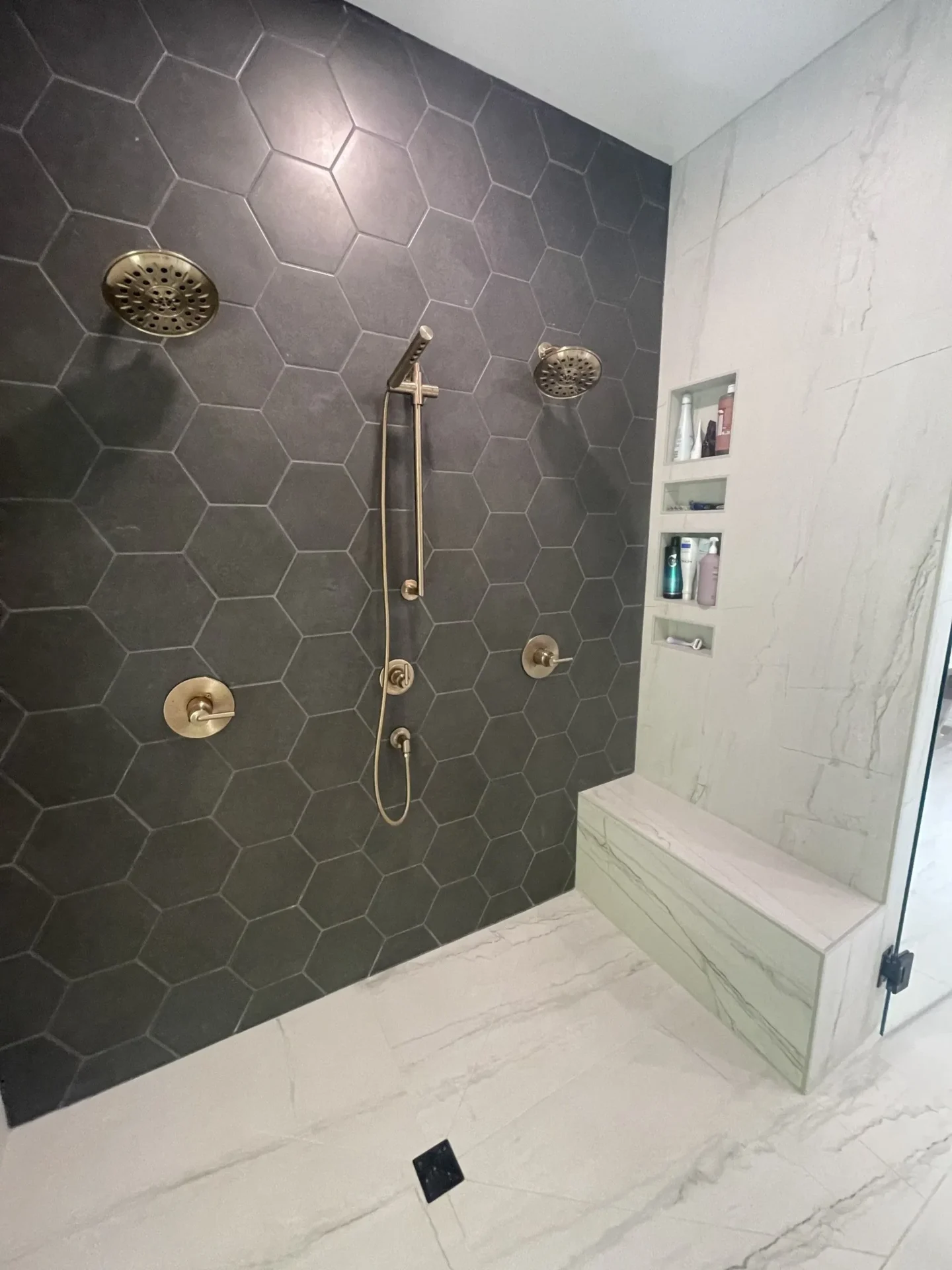 A bathroom with a shower and tiled walls.