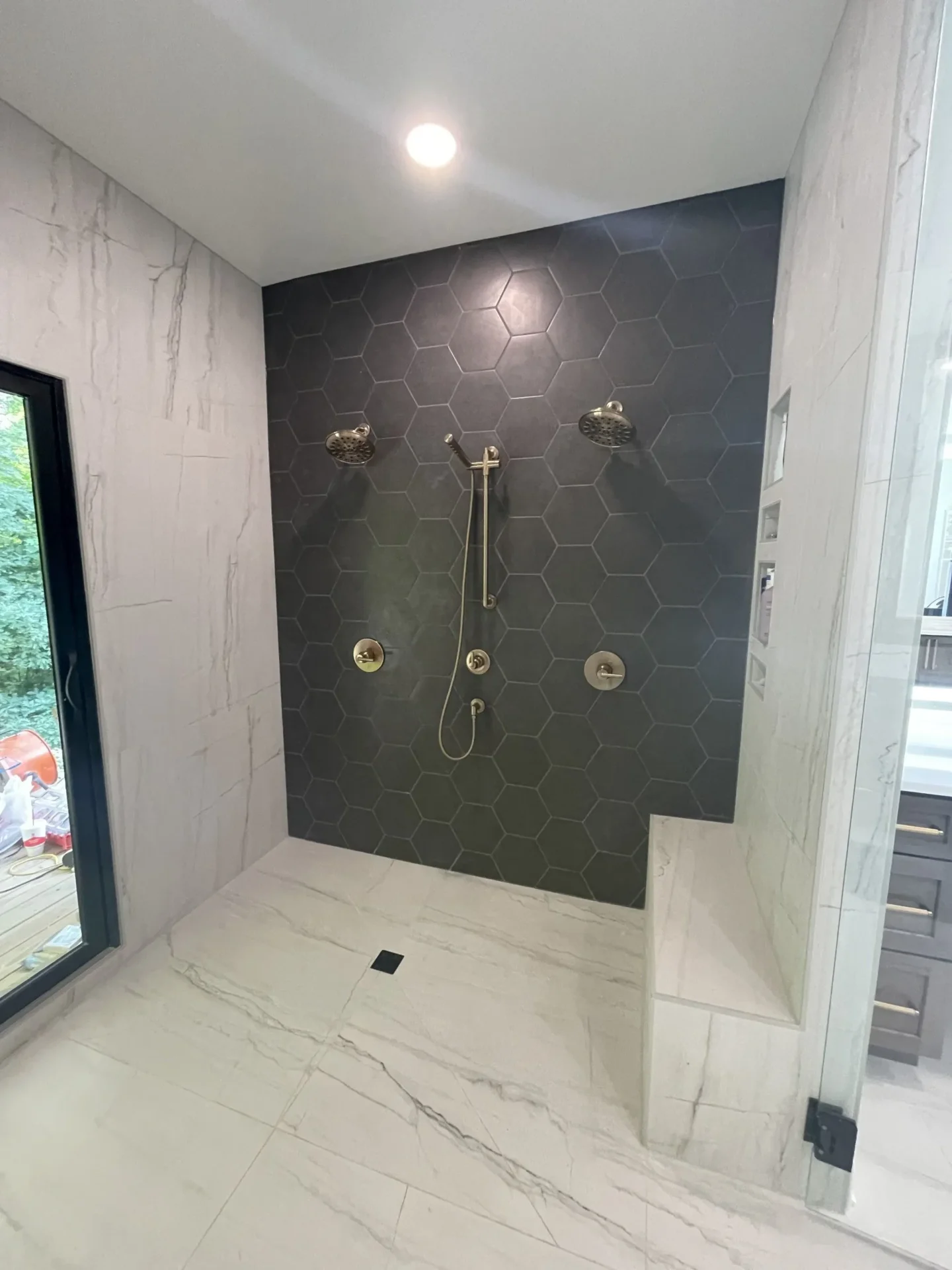 A bathroom with a shower and tiled walls.