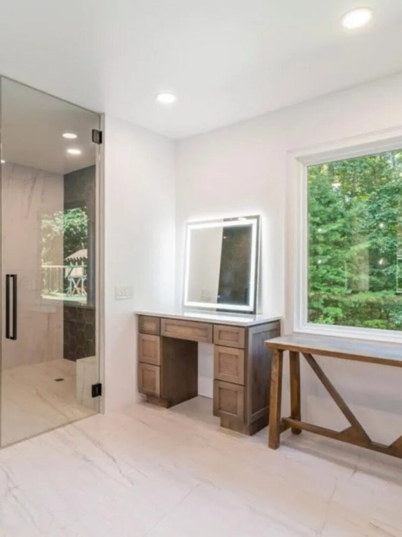 A bathroom with a vanity and mirror in it