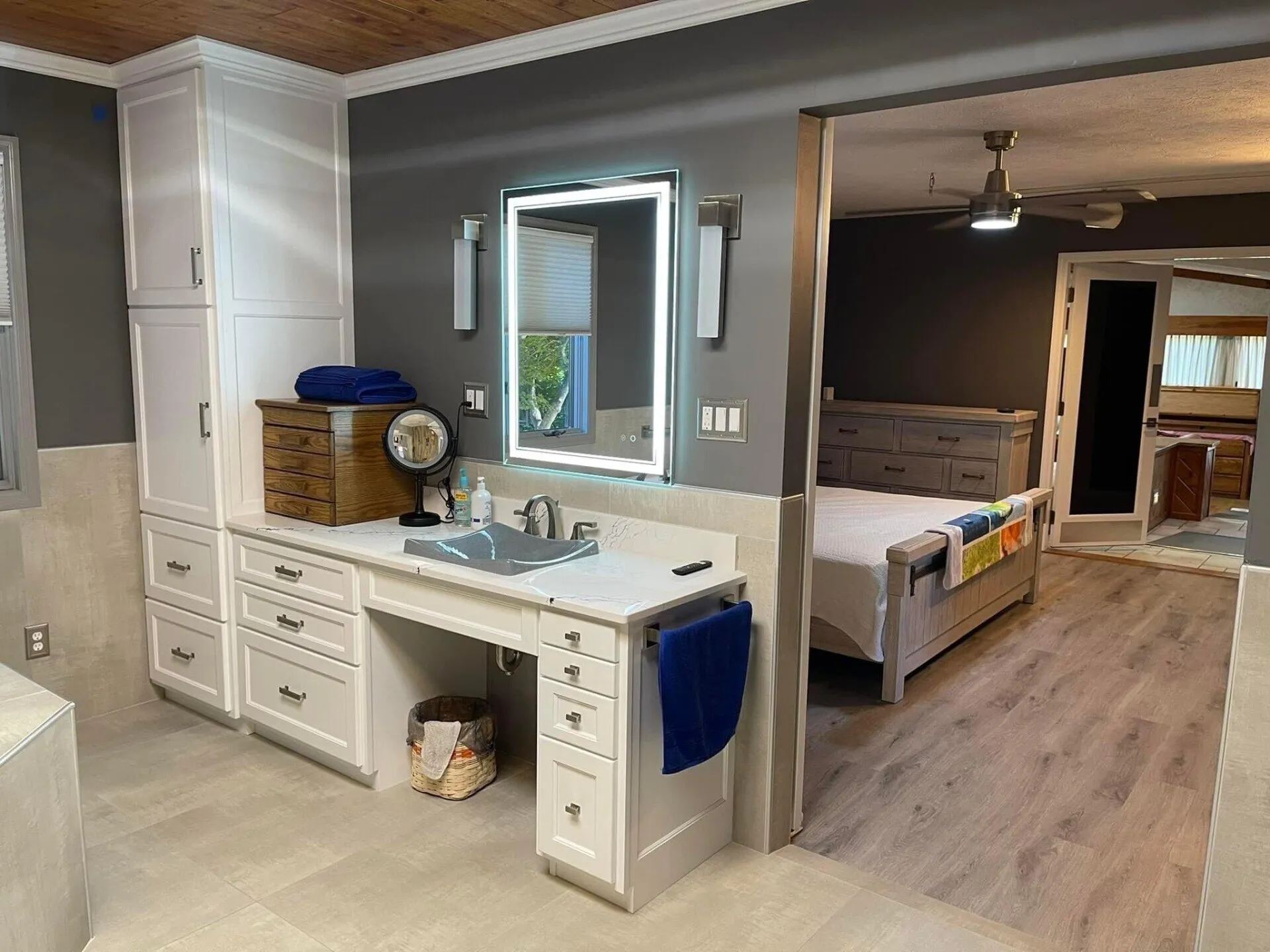 A bathroom with a sink, mirror and vanity.