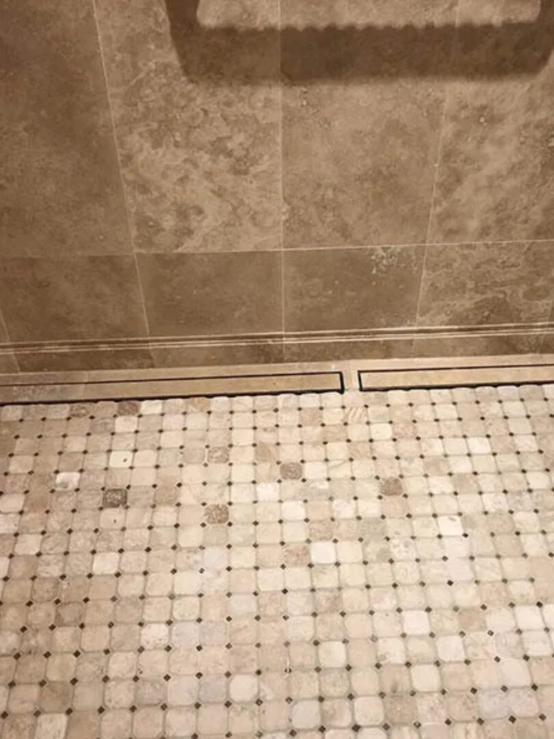 A bathroom with a tiled floor and walls