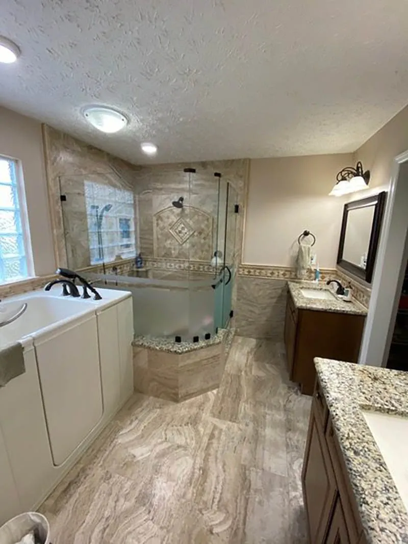 A bathroom with a tub, sink and mirror.